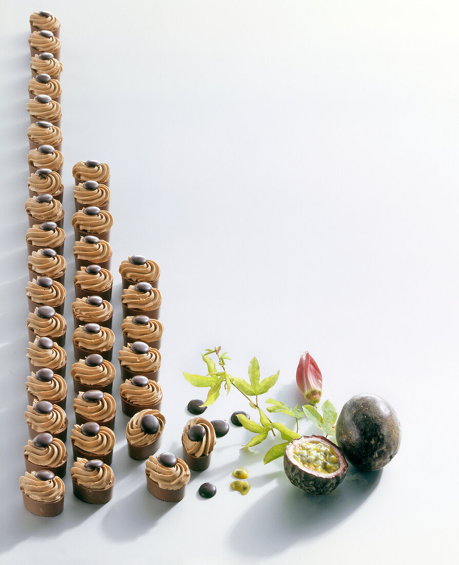 Cupcakes with passion fruit ganache and fresh passion fruit on white background