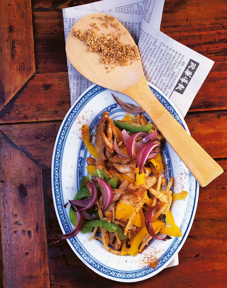 Stir-fried chicken with bamboo shoots, red onions and peppers