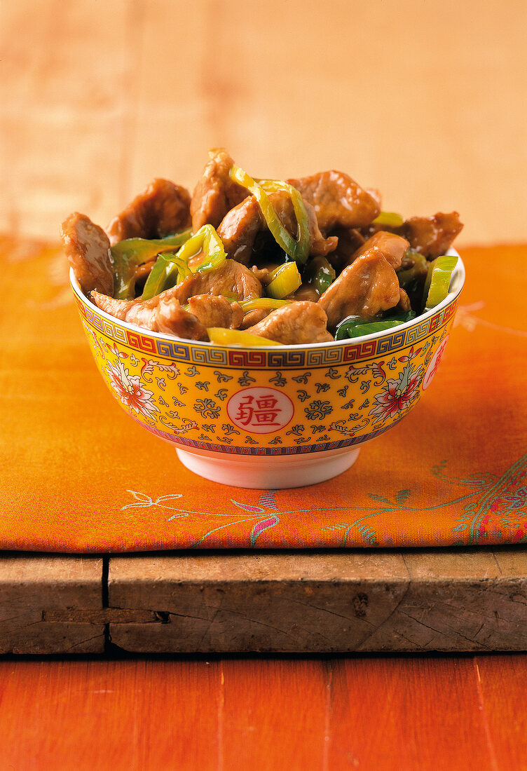 Spicy pork with leek and mu-err mushrooms in bowl