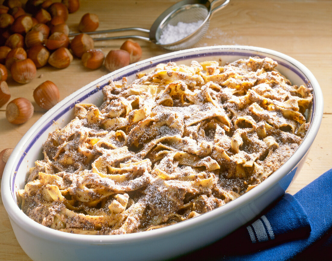 Bowl with baked pasta, chocolate and hazelnuts