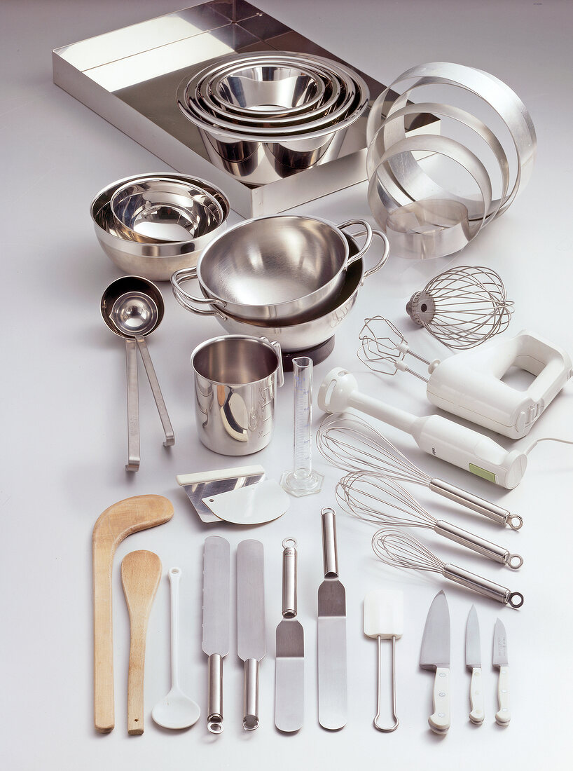 Variety of steel kitchen utensils on white background