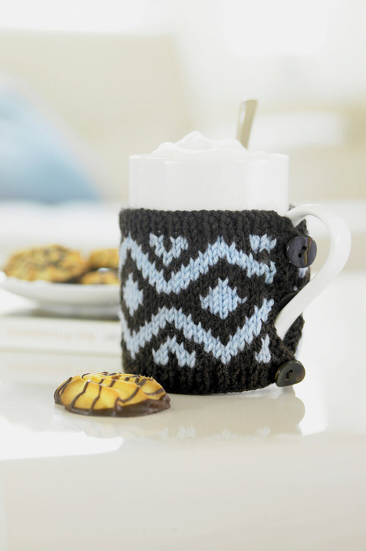 Cookies and cup in Norwegian pattern knitted cover