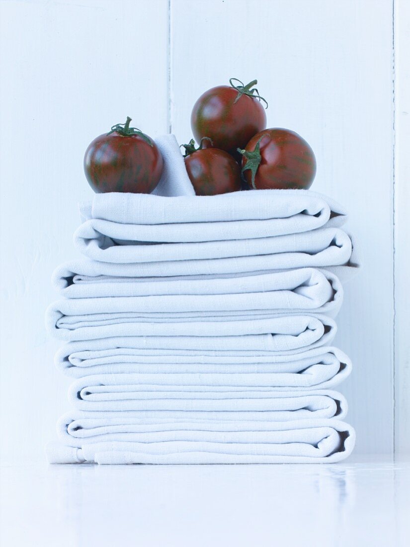 Black tomatoes on a stack of cloths