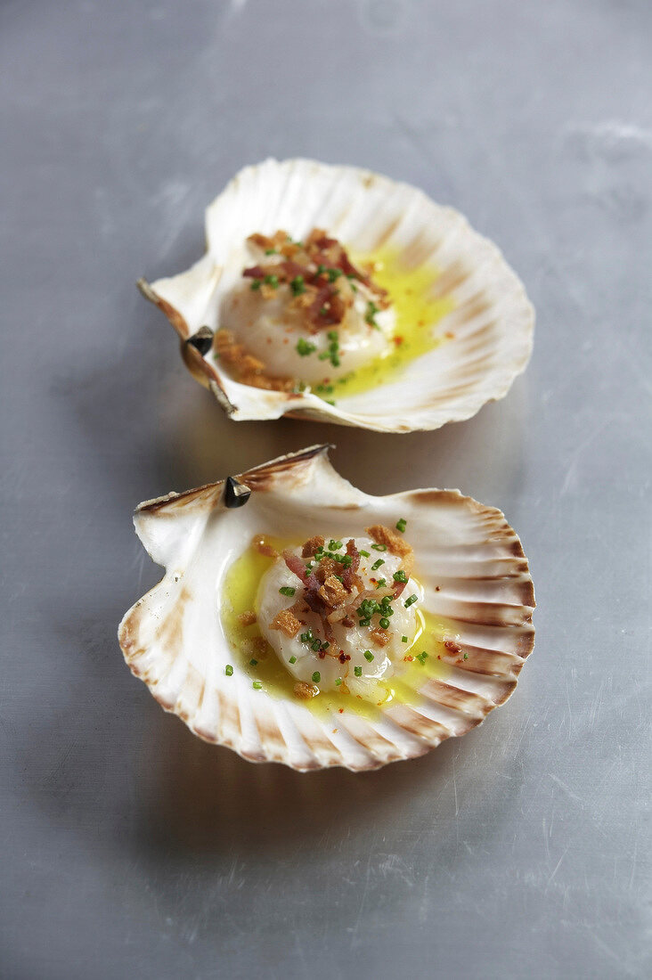 Two scallops marinated in lemon, olive oil and herbs
