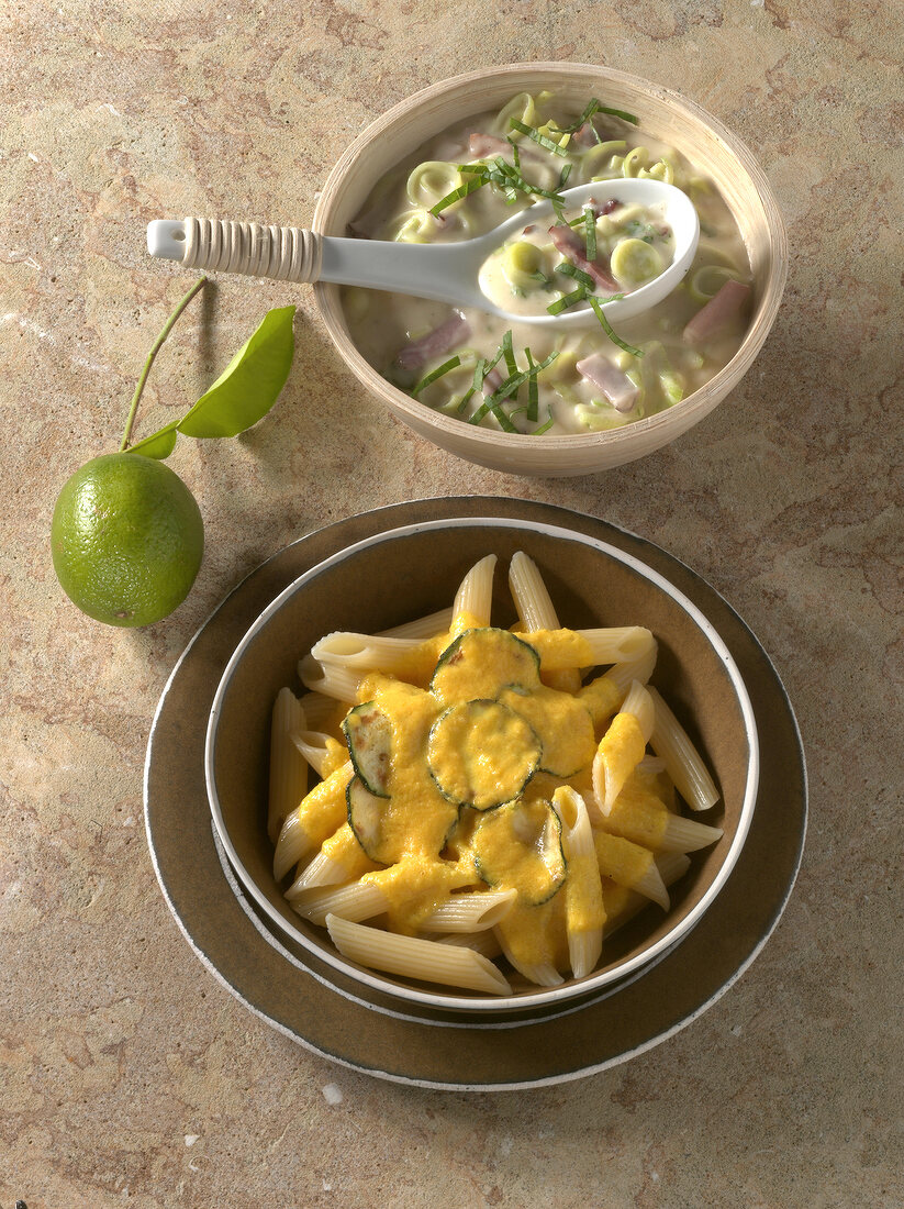 Leeks and lime sauce with penne, carrot and ginger sauce in bowls 