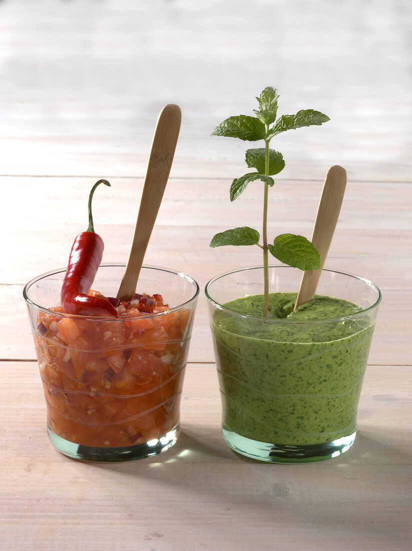 Tomato, grapefruit and verde salsa in two glass containers
