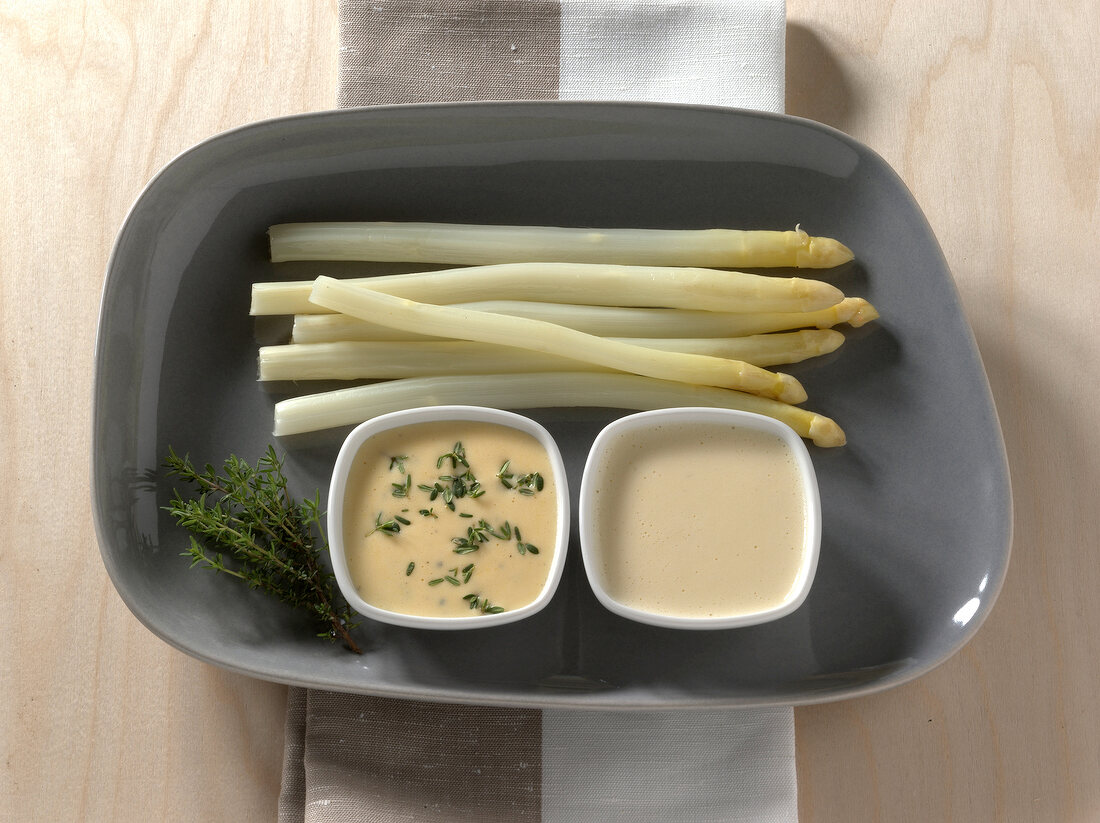 Thyme, hollandaise, pineapple and coconut butter sauce in bowls