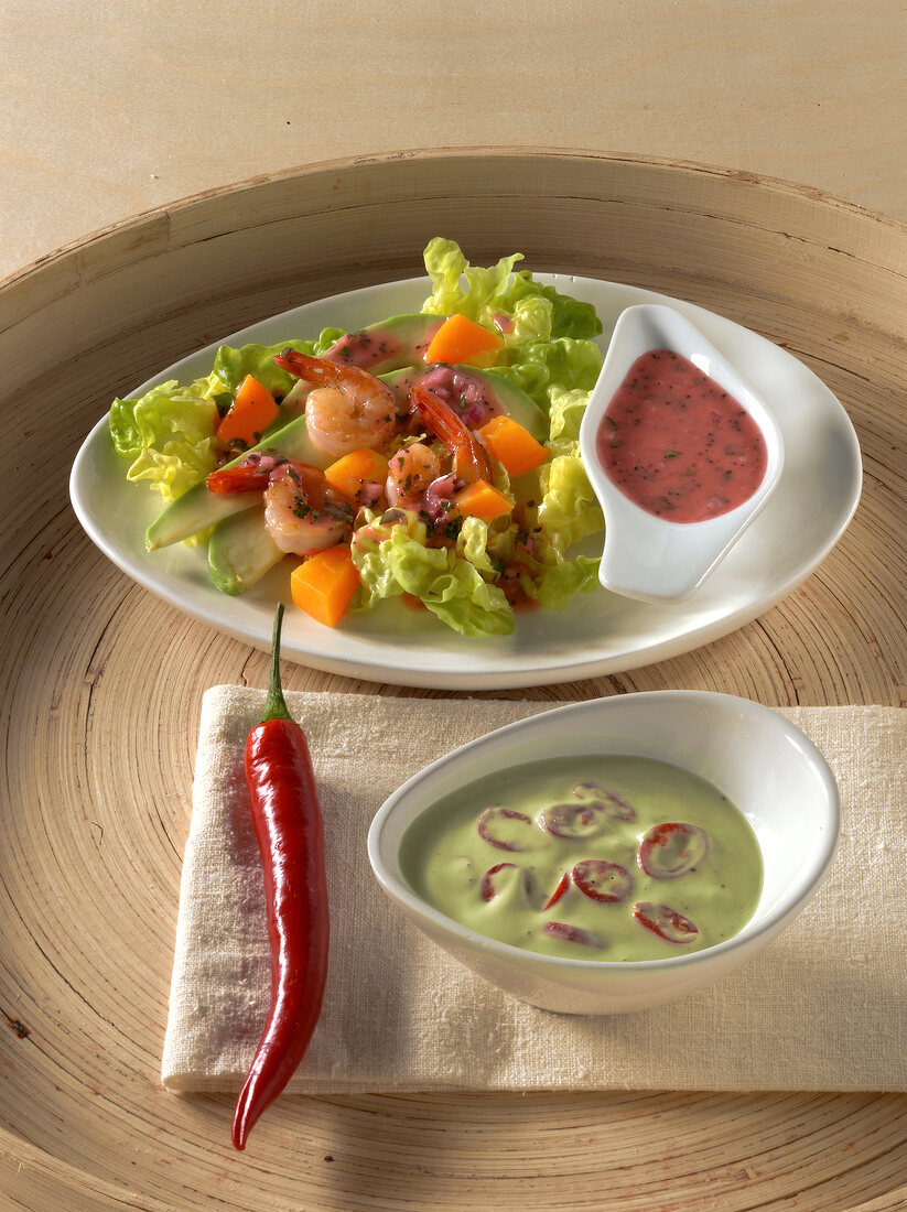 Salad with grapefruit, raspberry and avocado dressing on plate