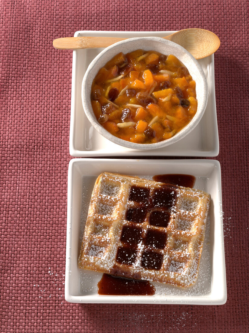 Waffle with prunes and cinnamon sauce in serving plate