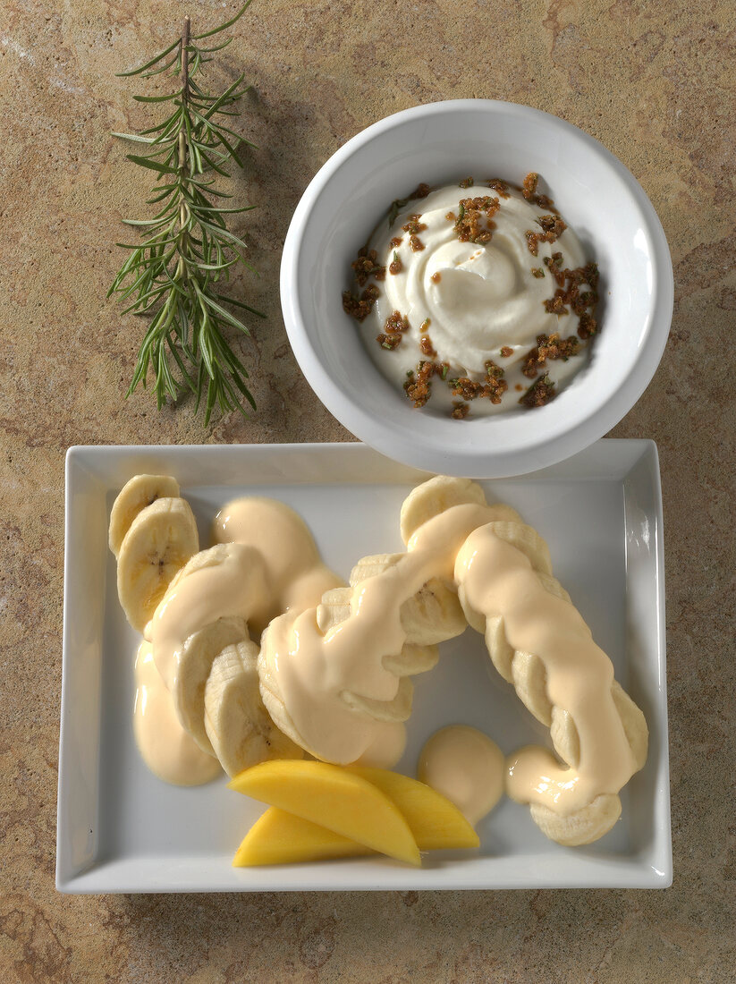 Mango and mascarpone sauce on plate with goat cheese cream in bowl