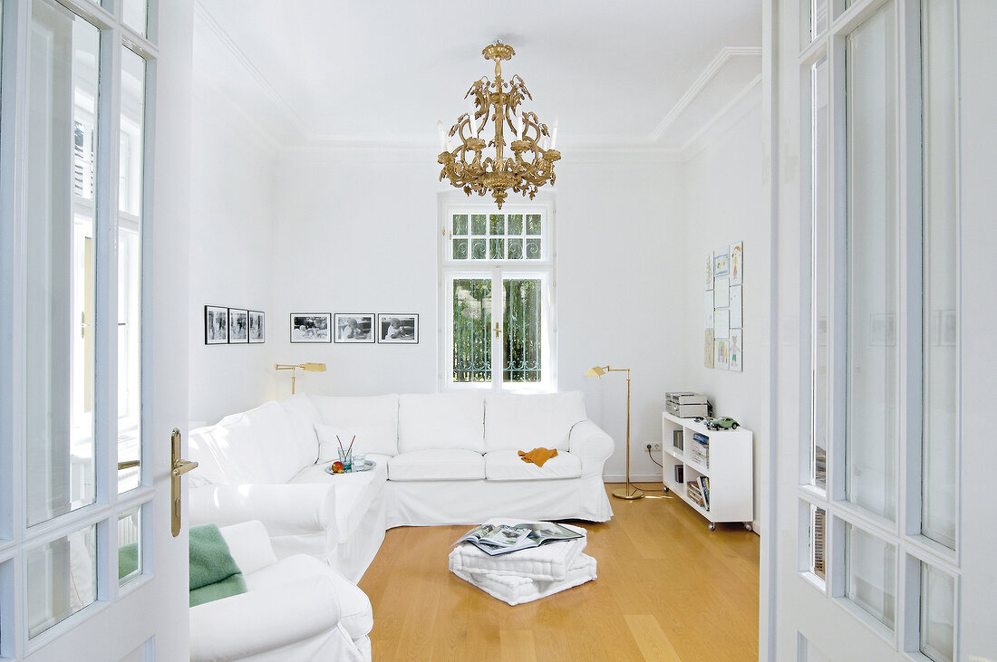 White living room with sofa and chandelier