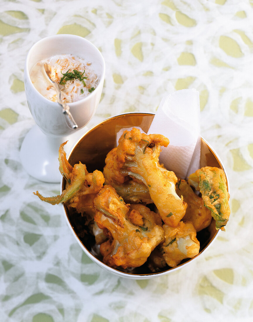 Cauliflower pakoras with coconut raita in bowls