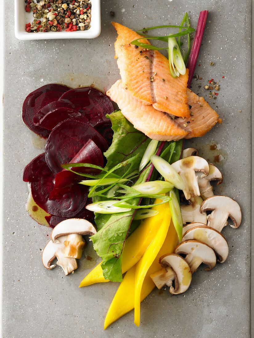 Close-up of beetroot salad with fillet of fish, overhead view