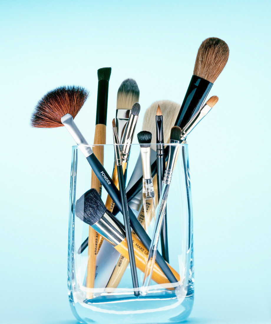 Various make-up brushes in glass