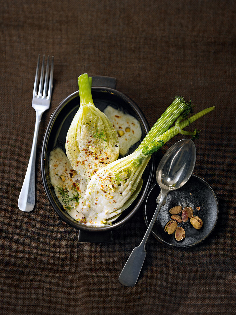 Over baked fennel with pistachios on serving dish