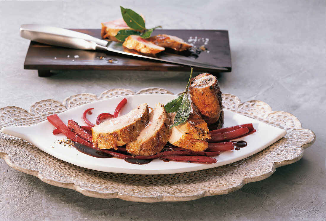 Pheasant breast fillet with bacon and white laurel on serving plate
