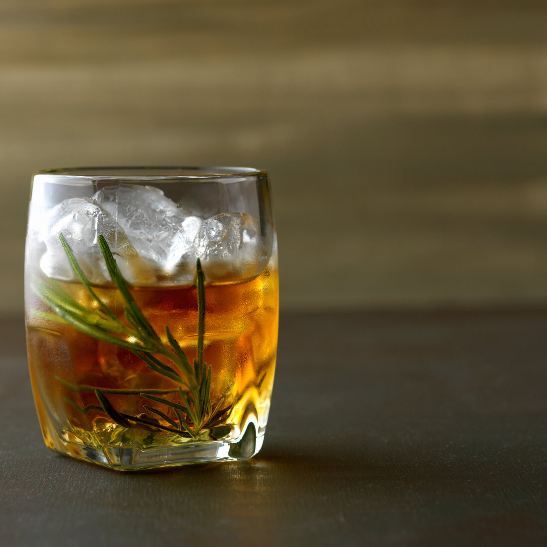 Rosemary with whiskey, rosemary and ice in glass