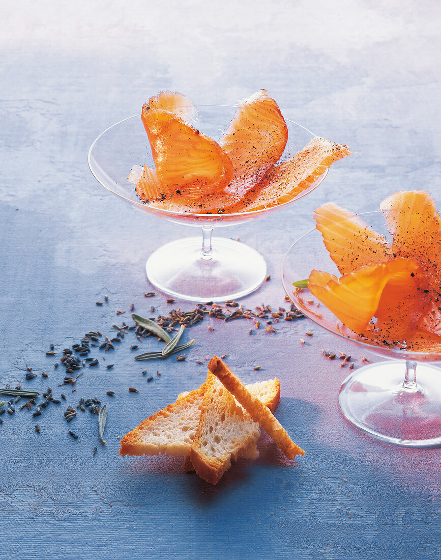 Marinated salmon with lavender in glass bowls