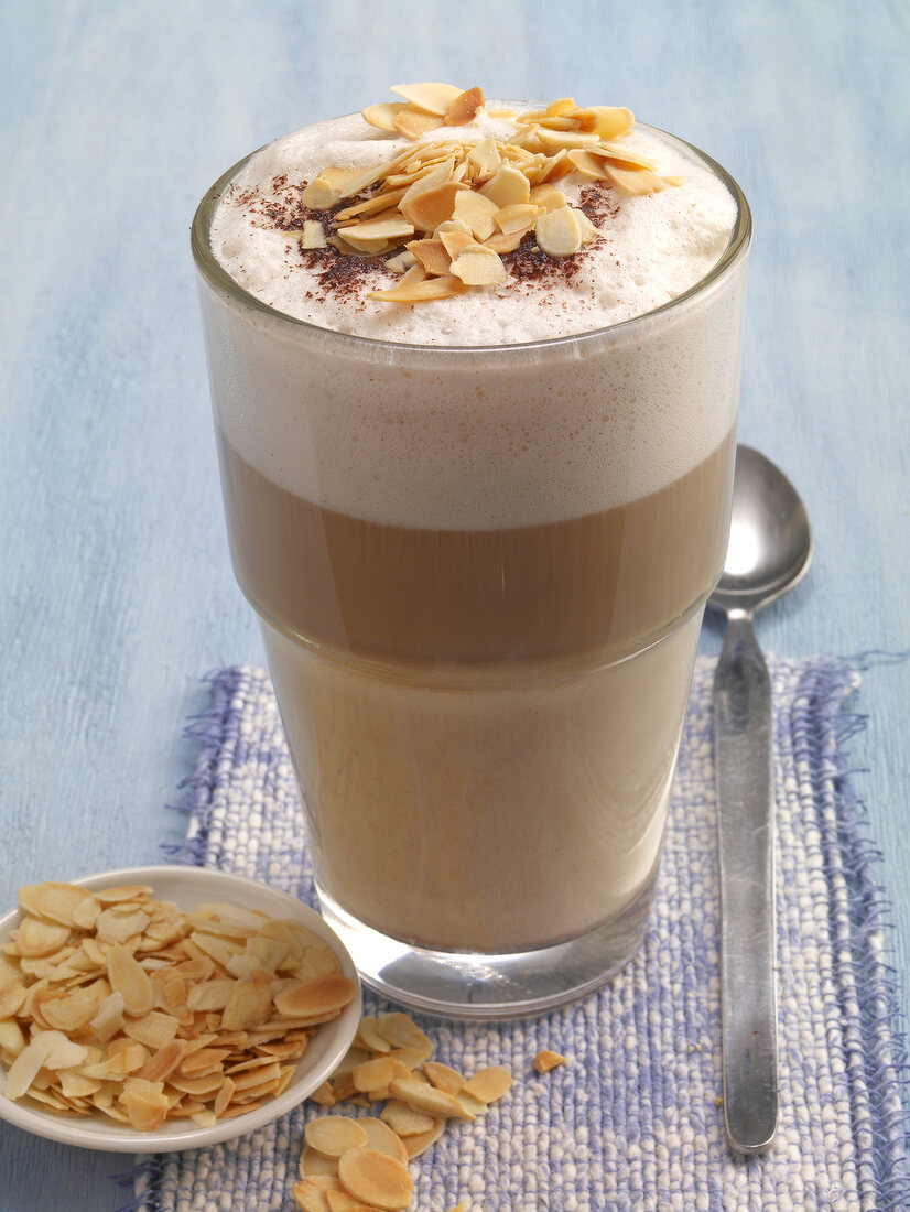 Almond chocolate milkshake with toasted flaked almonds in glass