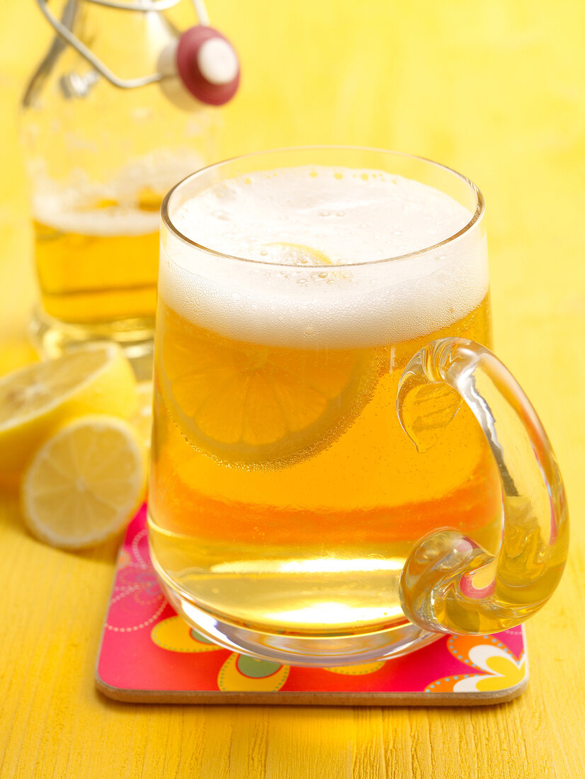 Cyclist royal cocktail with beer and lemon slices in beer glass