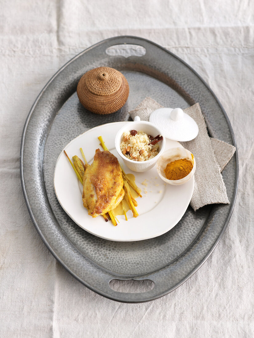 Turmeric and coconut chicken with lemon grass and couscous on tray