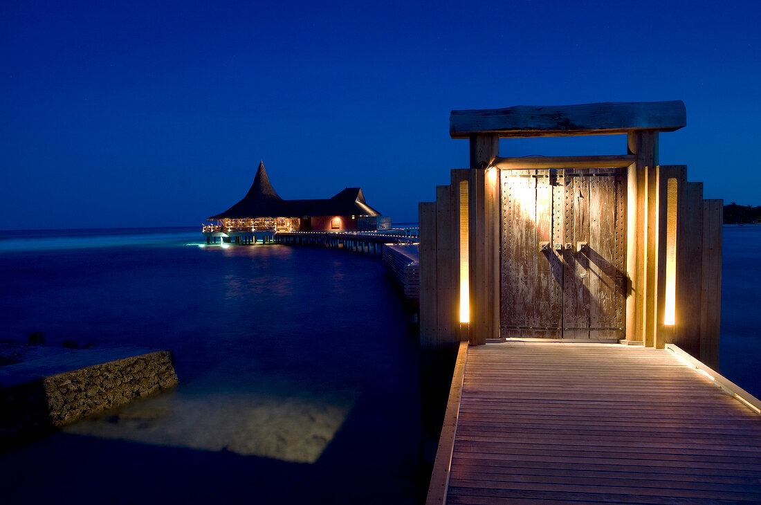 Illuminated dock huts on Dhigufinolhu island, Maldives