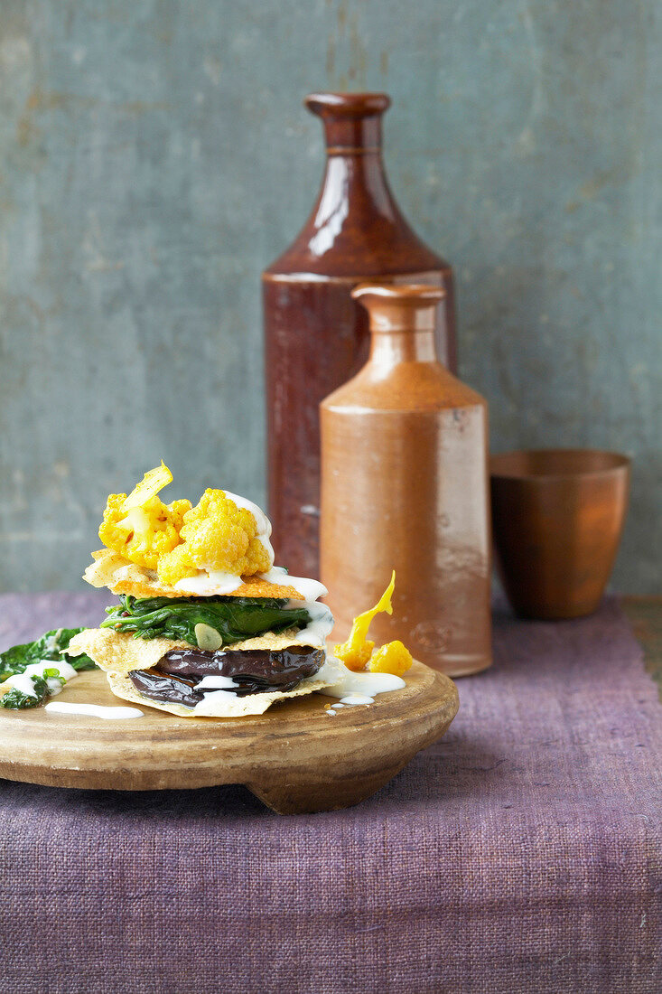 Pappadam and vegetables on wooden board