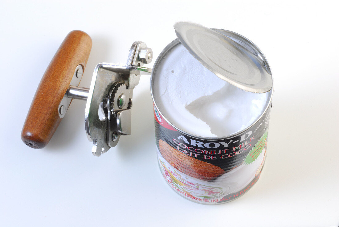 Opener and coconut milk can while preparing Thai curry, step 1