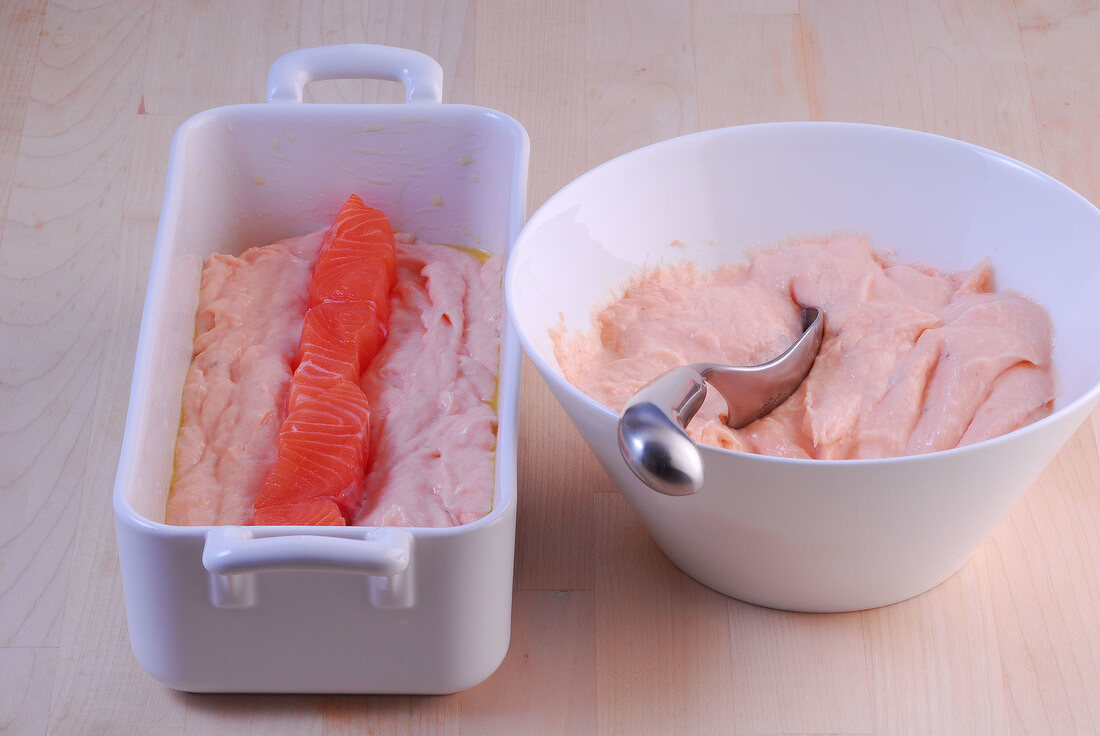 Salmon fillets and terrine mould in baking dish while preparing terrine farce, step 1