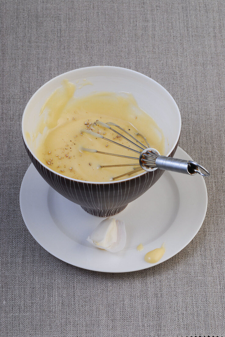 Homemade mayonnaise with whisk in bowl