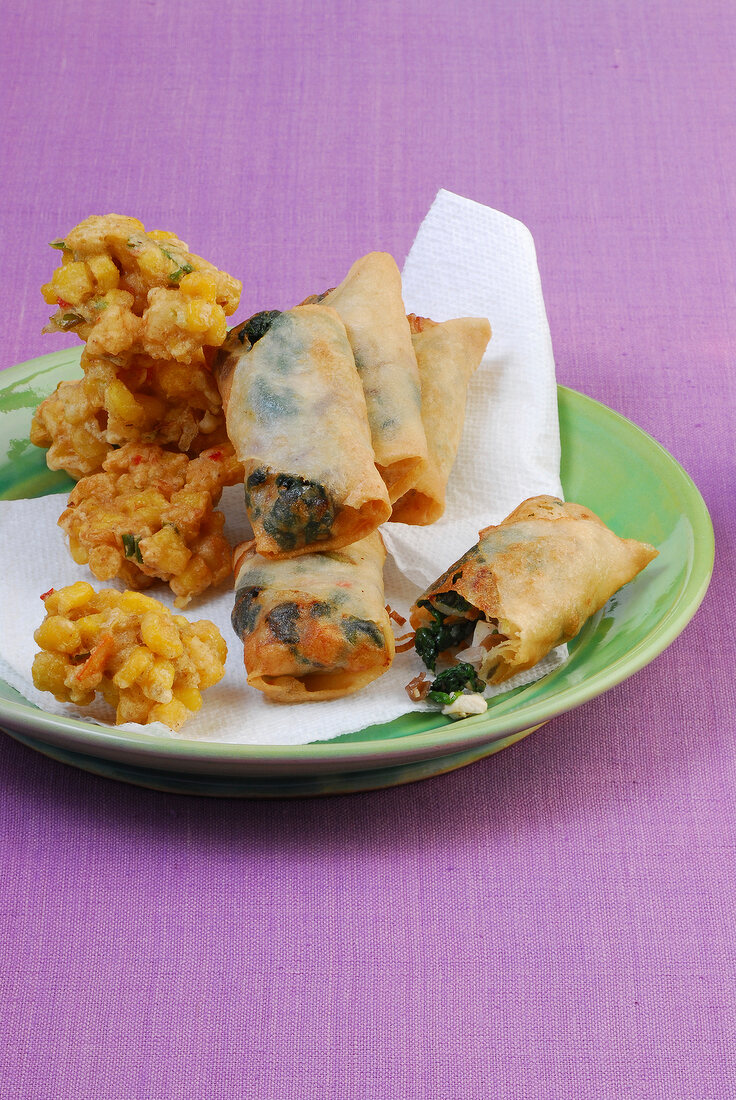 Fried markklossschen and small spring rolls on plate