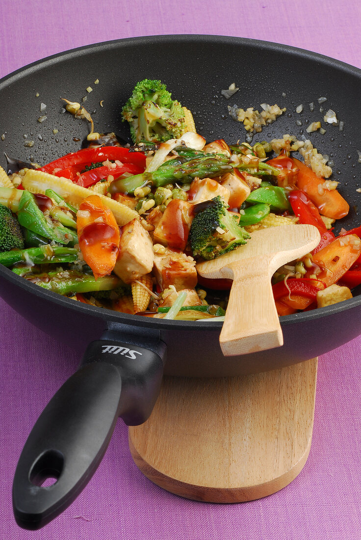 Mixed vegetables with marinated tofu and broccoli in frying pan