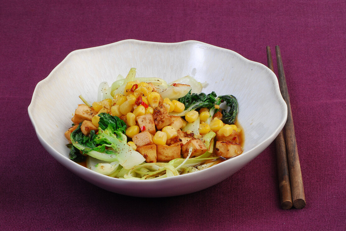 Tofu with bok choy, corn and leek in bowl