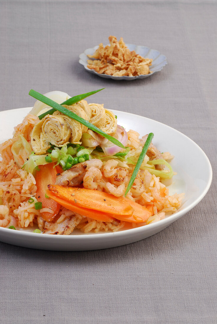Nasi Goreng with cabbage, carrots, pork and shrimp on plate