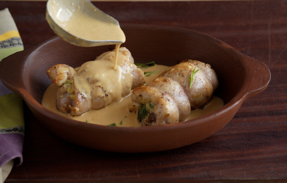 Rabbit legs with tarragon-mustard sauce in bowl