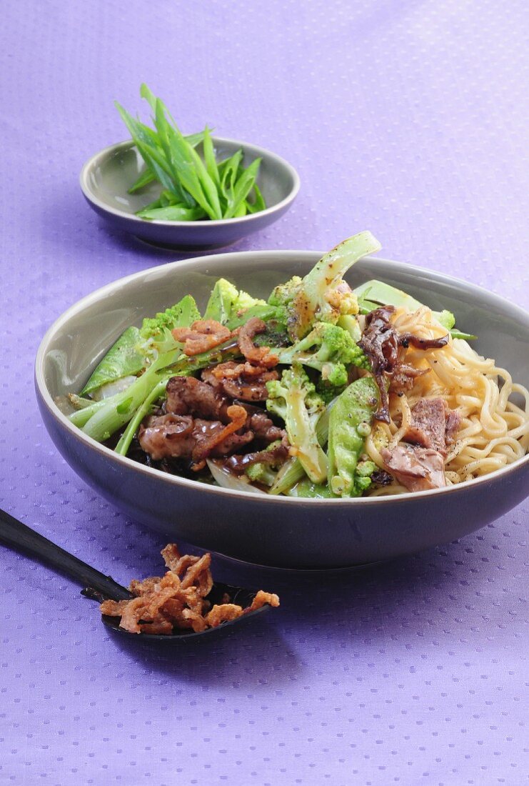 Duck breast on sesame seed noodles with Romanesco broccoli and mange tout