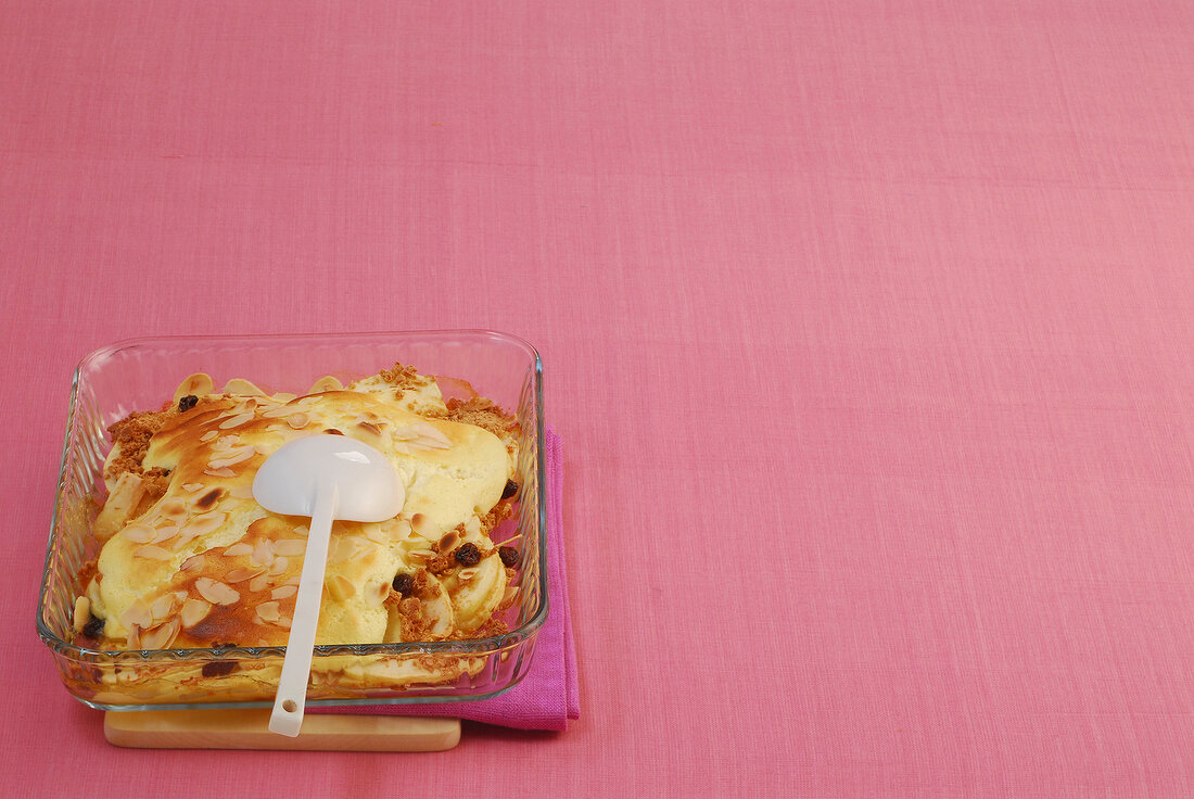 Apple and almond gratin in glass serving dish