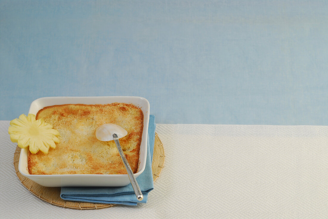 Baked pineapple and coconut rice pudding in serving dish