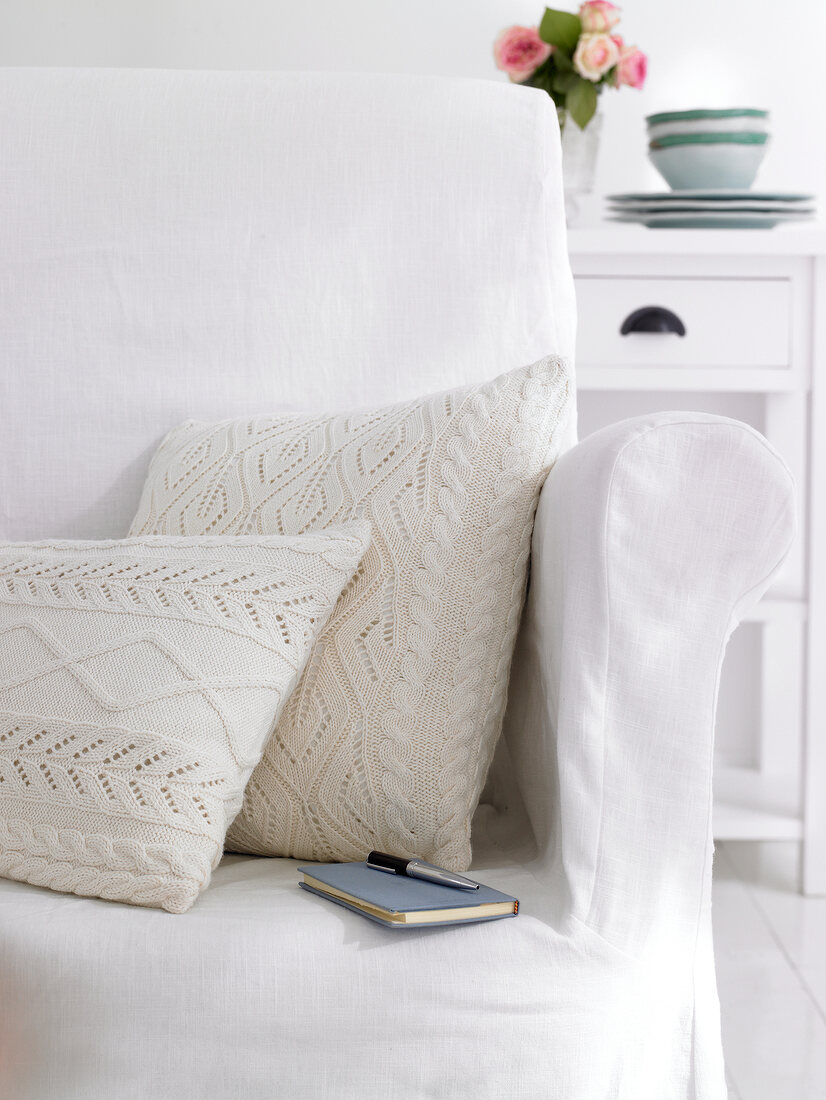 Pillow with white knitted covers on sofa