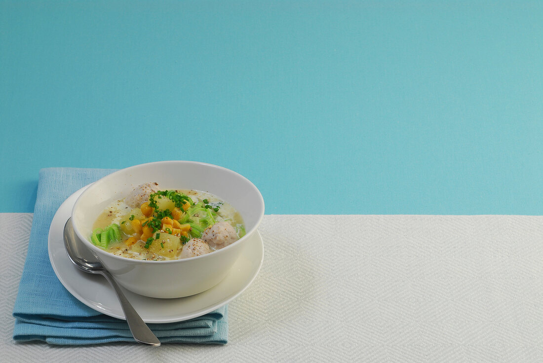 Corn soup with meat dumplings in bowl