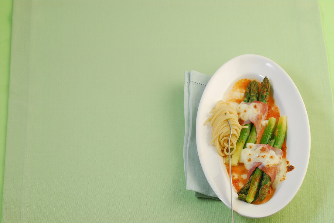 Baked ham and asparagus on plate