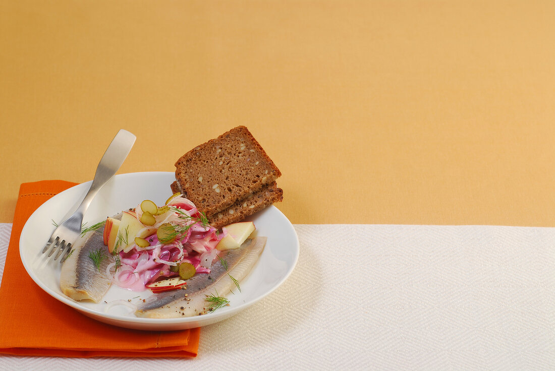 Herring with beetroot cream on plate