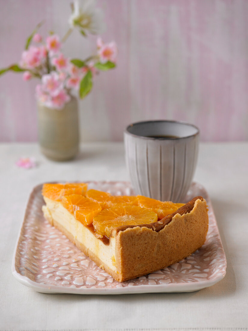 Cream cake with lemon and orange peel on serving dish