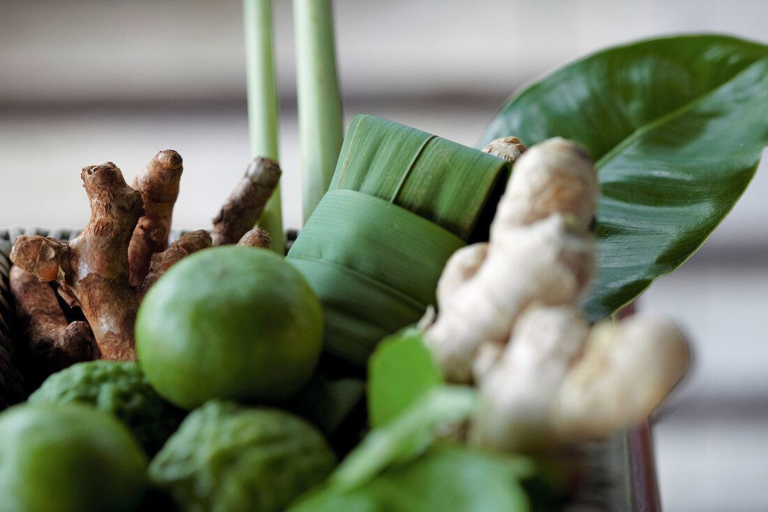 Close-up of fresh limes, ginger and ginseng