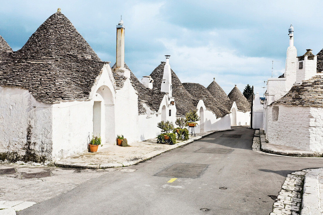 View of white house with conical roof in Alberobello, Italy