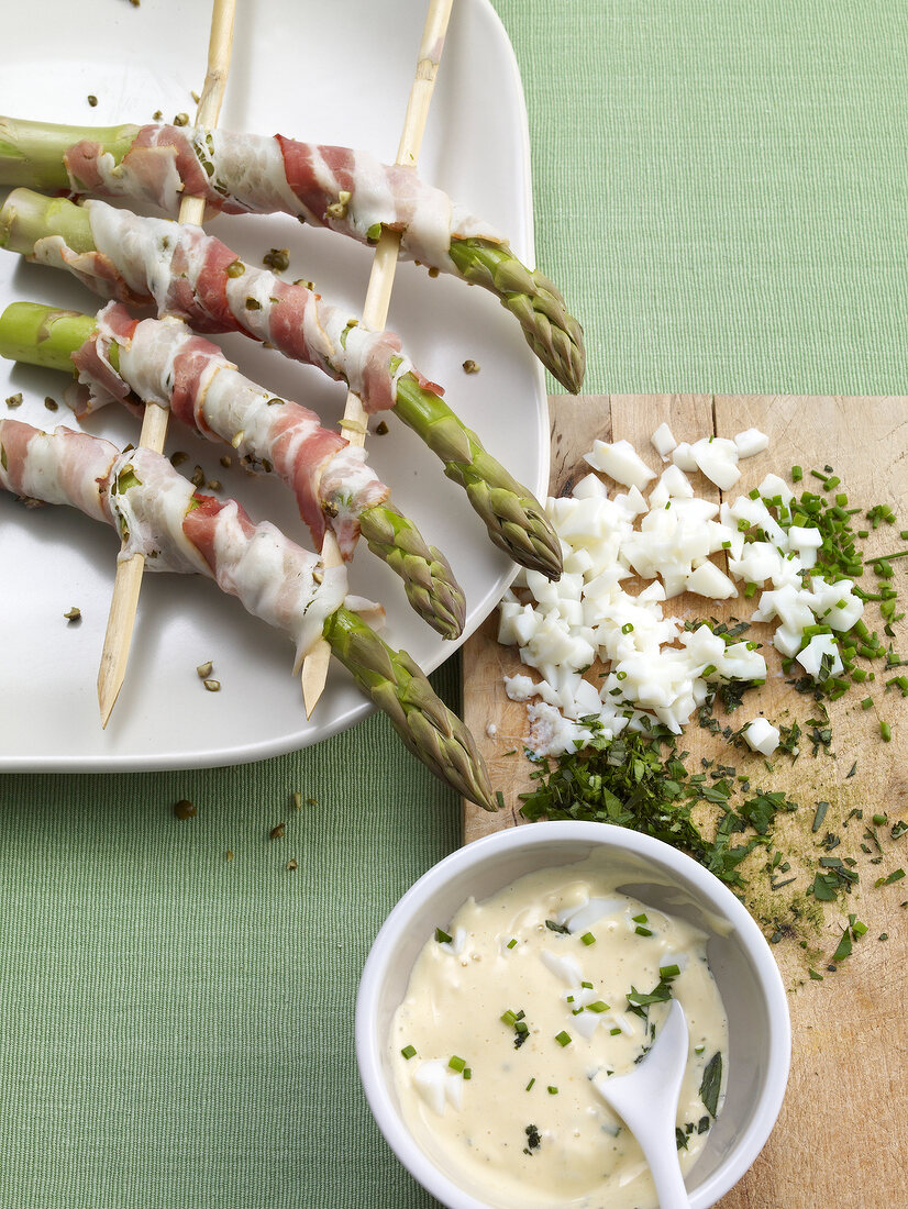 Asparagus and bacon kebabs with herb and egg sauce