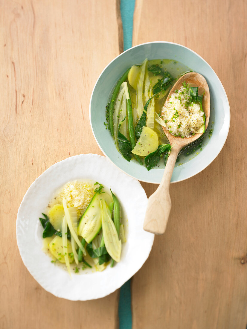 Vegetable soup with zucchini, fennel, beans, chard and couscous in bowl