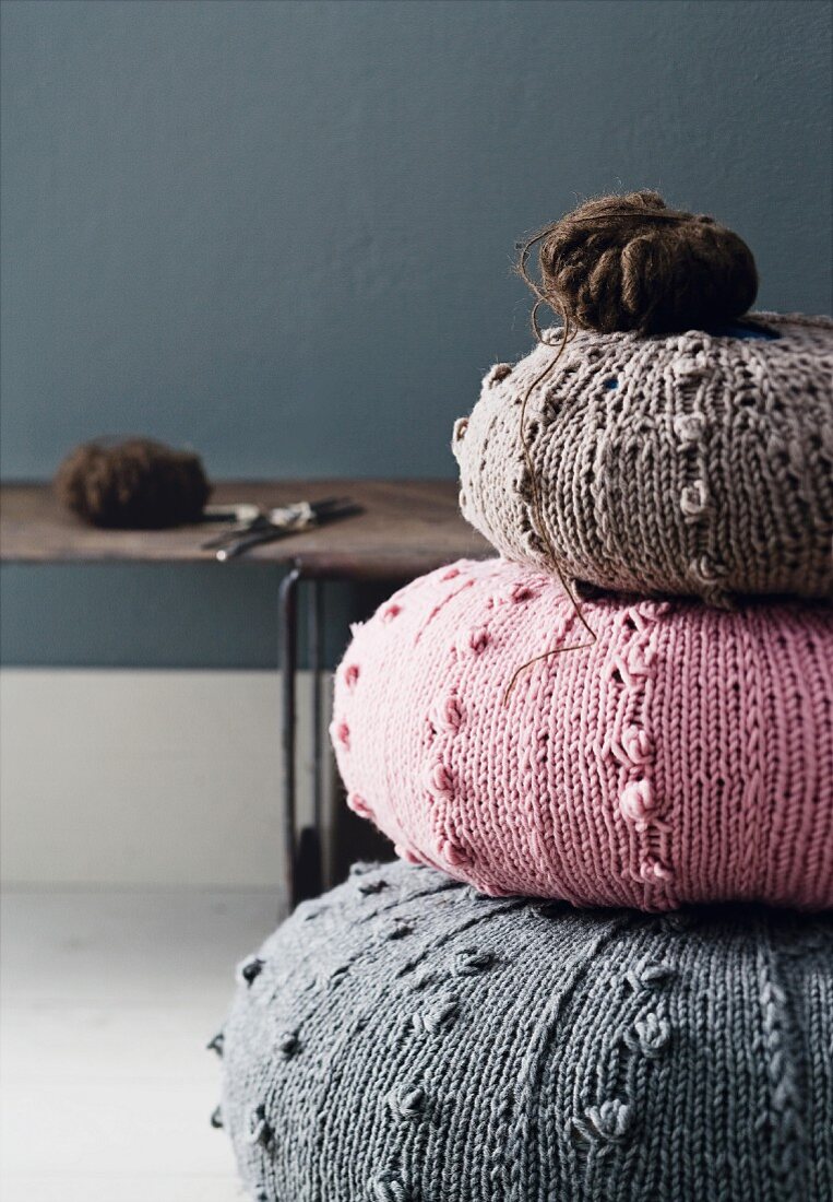 Round cushions with knitted covers