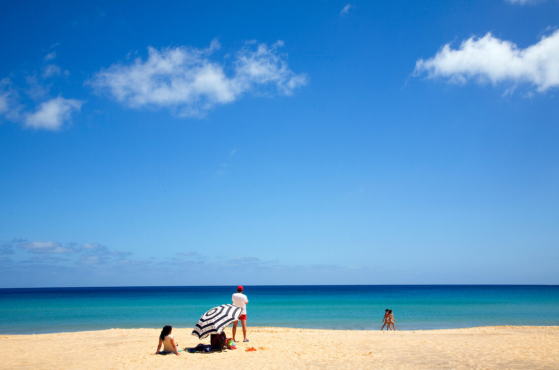 Tourist relaxing on beach of Porto Santo island, Madiera, Portugal