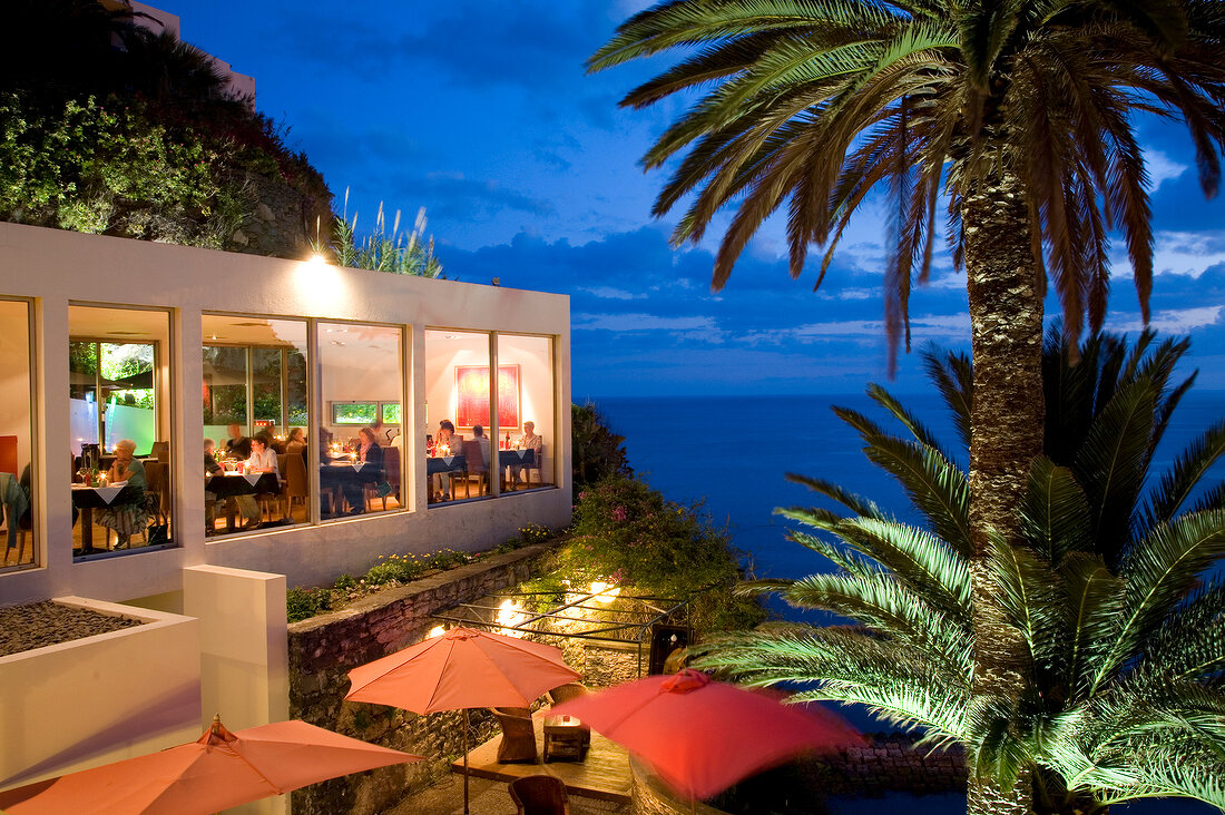Guests dining at Quinta da Rochinha restaurant in evening, Ponta do Sol, Madeira, Portugal